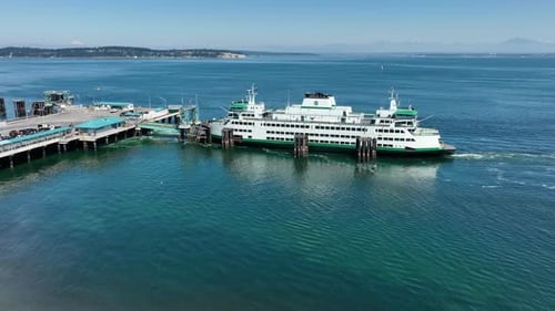Aerial of a docked WA State ferry unloading passengers.