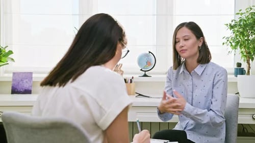 Woman Discussing Issues with Therapist in Office