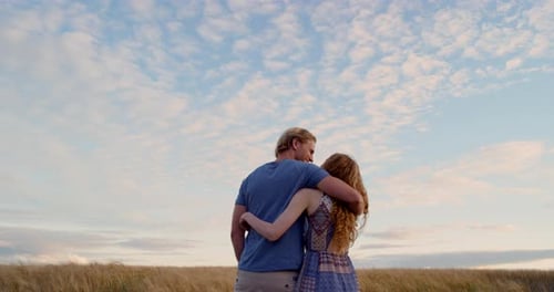 Romantic Couple Embracing in a Wheat Field at Sunset