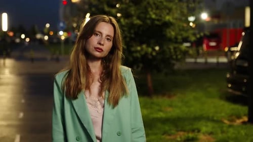 Night Portrait of a Beautiful Woman Against the Background of a Summer Alley at Night