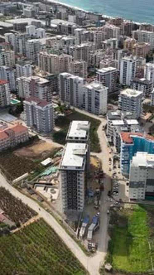 Vertical Video Construction Chronicles Aerial View of MultiStory Building Site in Progress
