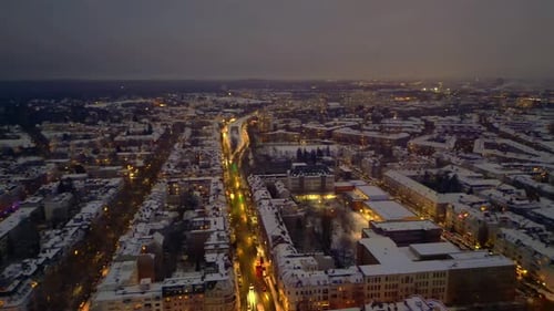 Berlin City lights, rooftops covering in snow winter at dusk. Best aerial view drone