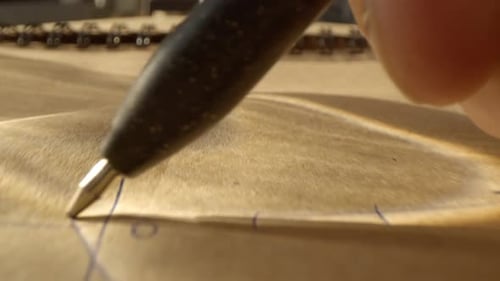 Drawing Lines on Brown Paper with Pen