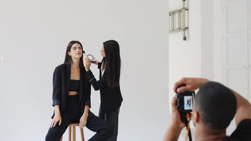 Model Getting Makeup Applied During Photoshoot
