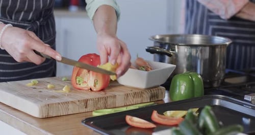 Woman Prepares Fresh Vegetables in Bright Kitchen