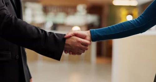 Hotel, reception and people with shaking hands for greeting, welcome or help for accommodation