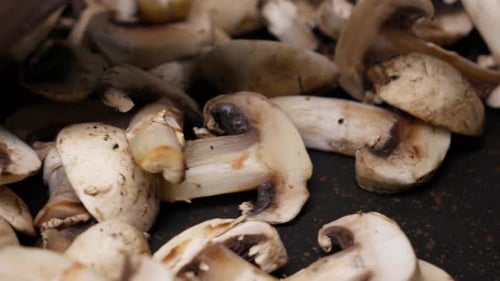 Champignons in der Pfanne mit einem Holzlöffel umrühren und aus nächster Nähe kochen
