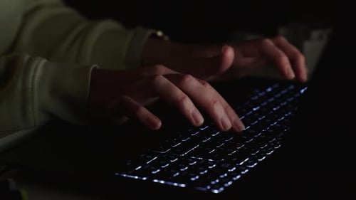 Typing on Laptop Keyboard at Night Close Up