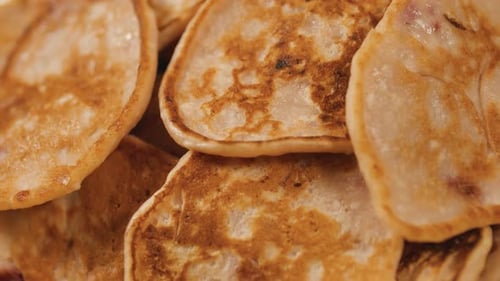 Rotating Plate with Strawberry Fritters Pancakes Close Up Top View