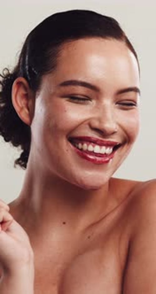 Face, woman and smile with beauty in studio for skincare, healthy skin and shine of smooth textures