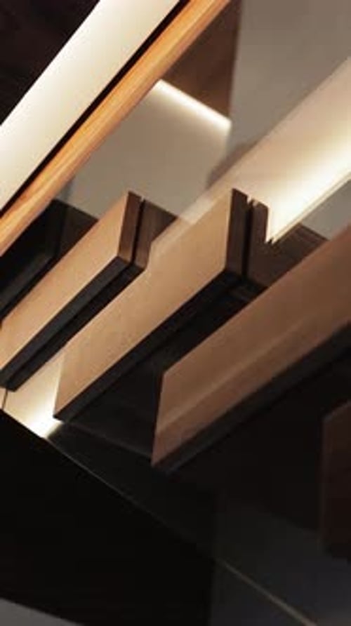 A Closeup Shot of a Stylish Wooden Stairs Complemented By Modern Lighting