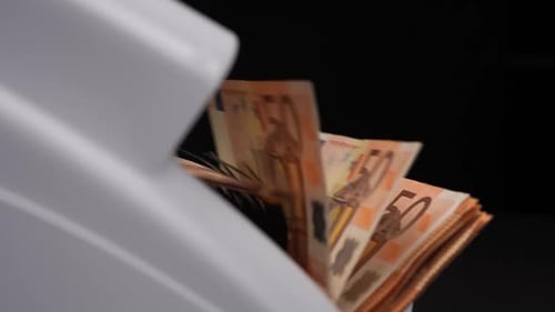 Machine Counting Out Numerous Euro Bank Notes