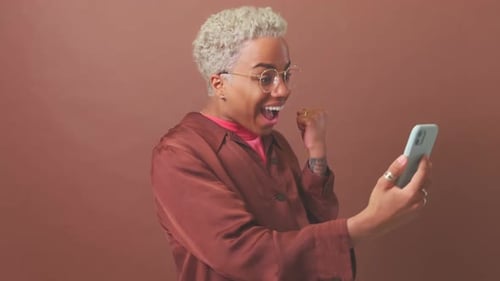 Excited Young Adult Celebrates Good News on Phone