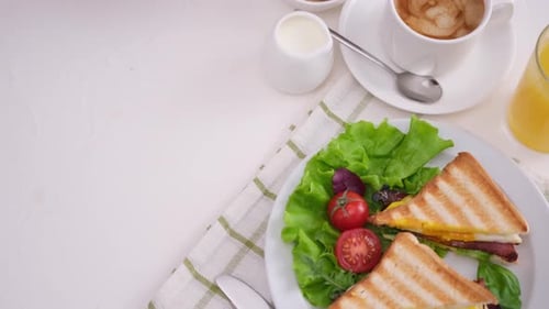 Tasty Breakfast with Egg and Sandwich on Table