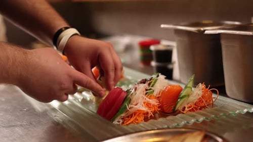 Chef prepares seafood dishes in a Japanese restaurant