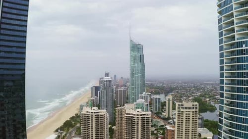 4k drone footage of a coastline alongside a city