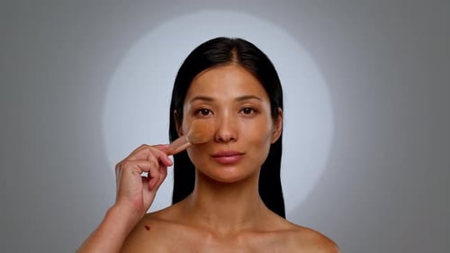Woman Applying Makeup Powder with Brush