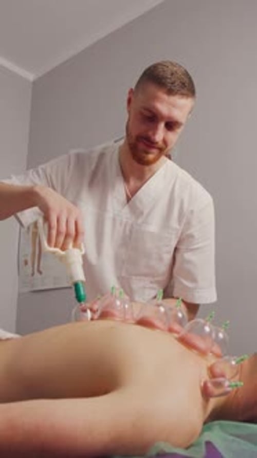 Cupping Therapy In the Spa Salon the Massage Therapist Makes a Vacuum Massage Vertical Video
