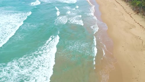 Aerial View of Tropical Sandy Beach and Blue Ocean Top View of Ocean Waves Reaching Shore on Sunny