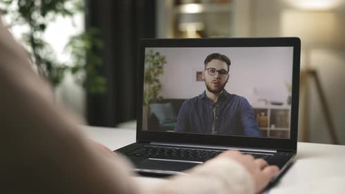Woman on Video Call with Man on Laptop