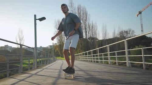 Man Ride Skateboard on Bridge