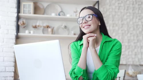 Woman Works at Laptop in Bright Home Office