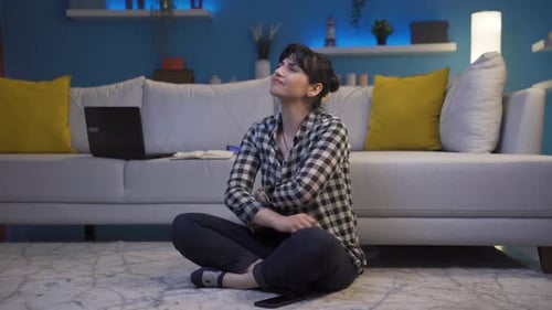 Woman Sitting on Floor with Crossed Legs Indoors