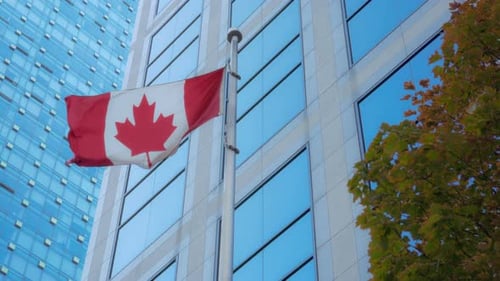 Canadian Flag Waving in the Wind in City