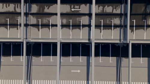 Multi-storeyed parking lot in neighborhood with meticulously organized concrete structure