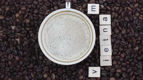 Top View of a Cup of Coffee on a Background Coffee Beans with the Inscription Vietnam