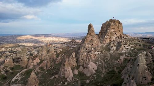 Aerial drone view of the Uchisar Castle in Cappadocia, Turkey during sunset