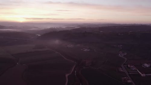 Aerial view of foggy sunrise over traditional houses, Portugal.
