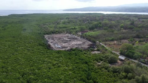Rubbish tip, landfill, waste area in Lembongan Bali drone wide pan shot