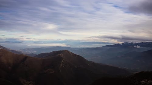 beautiful time lapse over the clouds on top of a mountain