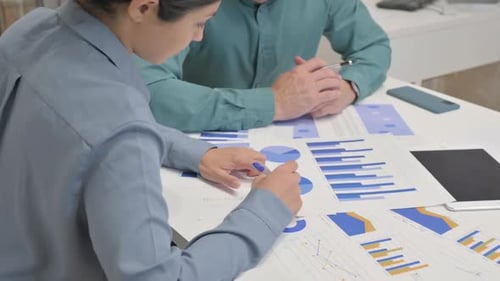 Close Up of Multi Ethnic People Doing Paperwork