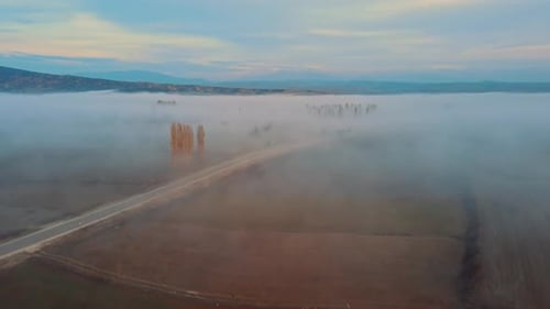 A Road In Fog Covered Terrain