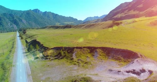 Aerial Rural Mountain Road and Meadow at Sunny Summer Morning Asphalt Highway and River