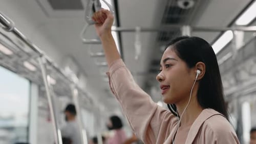 Young Woman Riding a Brightly Lit Train