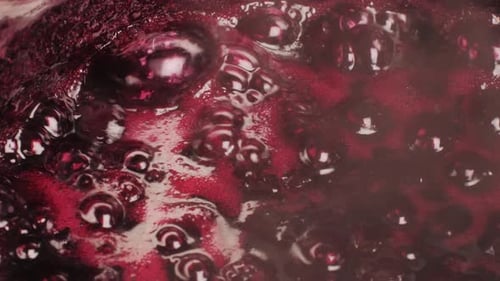 Close-Up of Bubbling Red Berry Jam Boiling