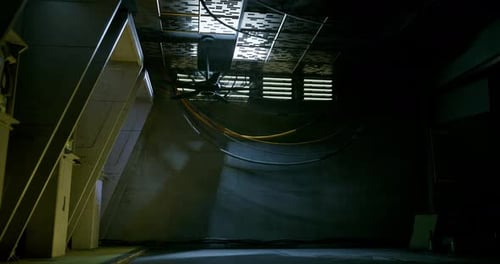 Dark Industrial Room with Flickering Lights and Moving Shadows