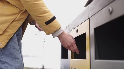 Adult Disposing of Plastic in Recycling Bin