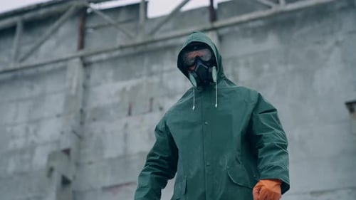 Man in gas mask on destroyed building background