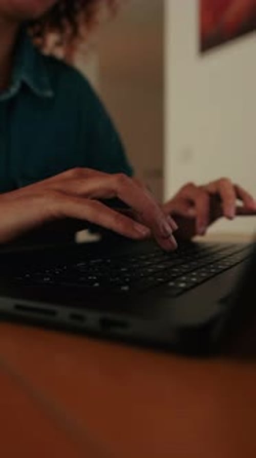 Woman hands using typing on laptop notebook keyboard sit at home close up side view