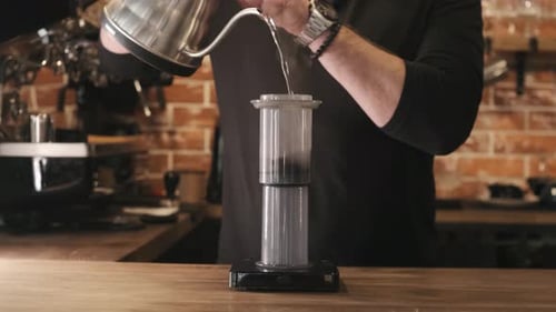 Pouring Water Into Coffee Maker