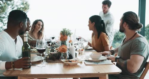 Adults Enjoy Food and Wine at Table