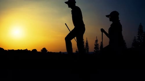 Silhouetted Golfers Play Golfing at Beautiful Sunset