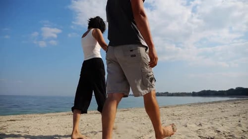 Couple Holding Hands of Each Other and Walking at Coast Happy Pair Going Along Seashore at Sunny Day