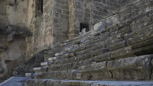 The Camera Rises Up Along the Steps of the Ancient Amphitheater