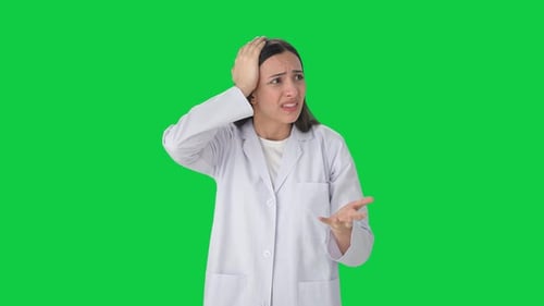 Stressed and tensed Indian female scientist Green screen