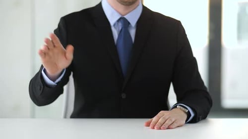 Businessman interacting with invisible augmented reality technology in office